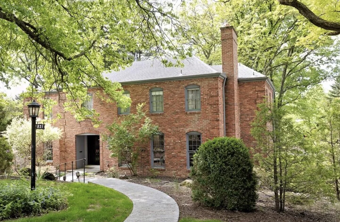 Traditional brick colonial estate framed by mature trees, South Hills Pittsburgh luxury real estate